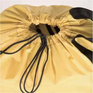 Close-up of a yellow bag's drawstring closure with a black cord lock