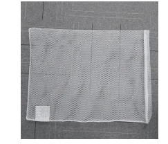 White rectangular mesh laundry bag with a zip closure