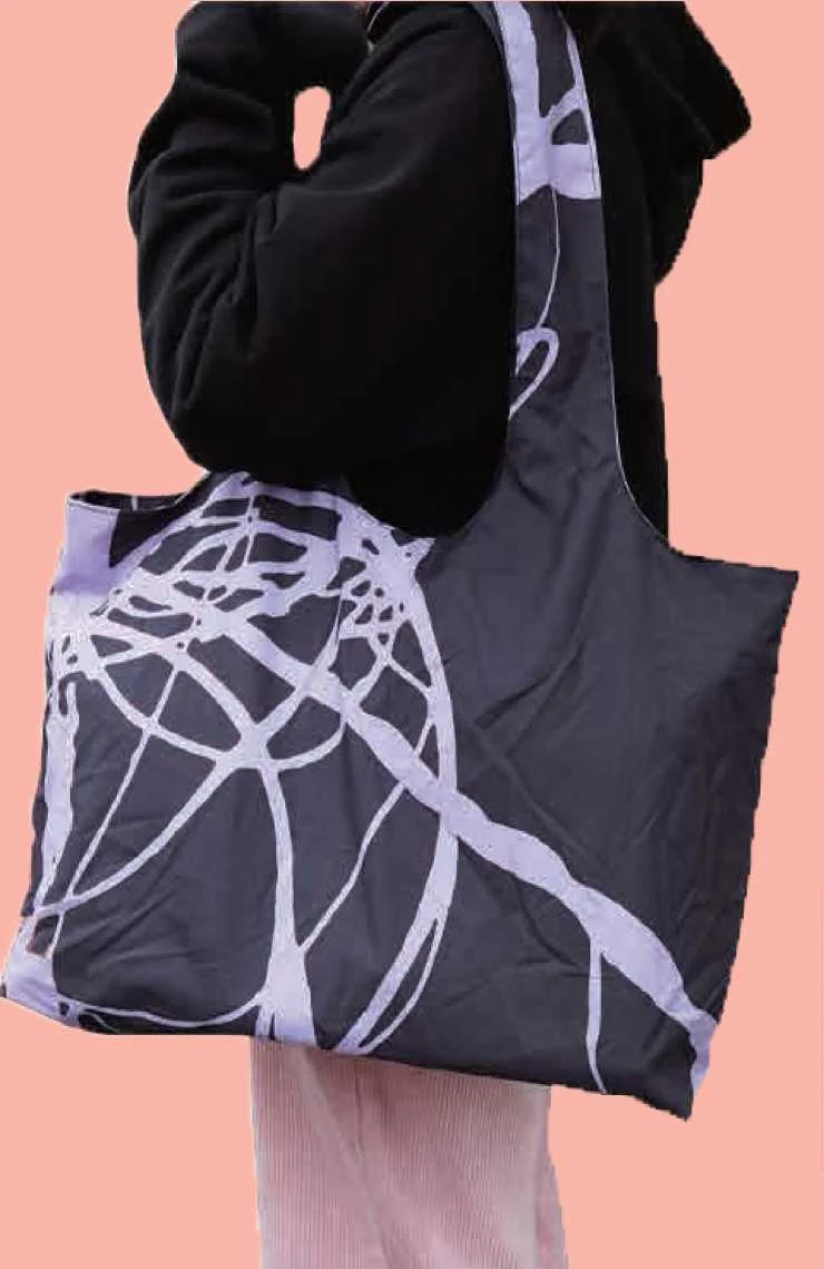 Dark fabric shoulder bag with a light abstract print