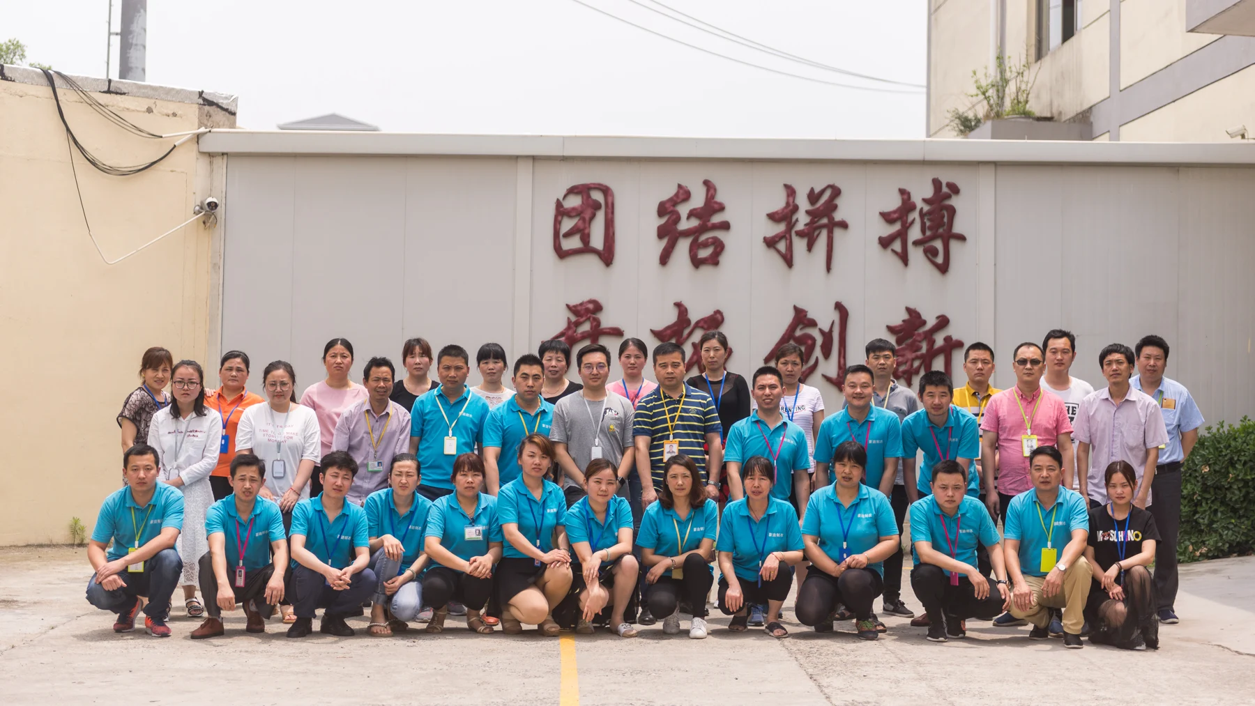 Garment factory team posing for a group photo outdoors