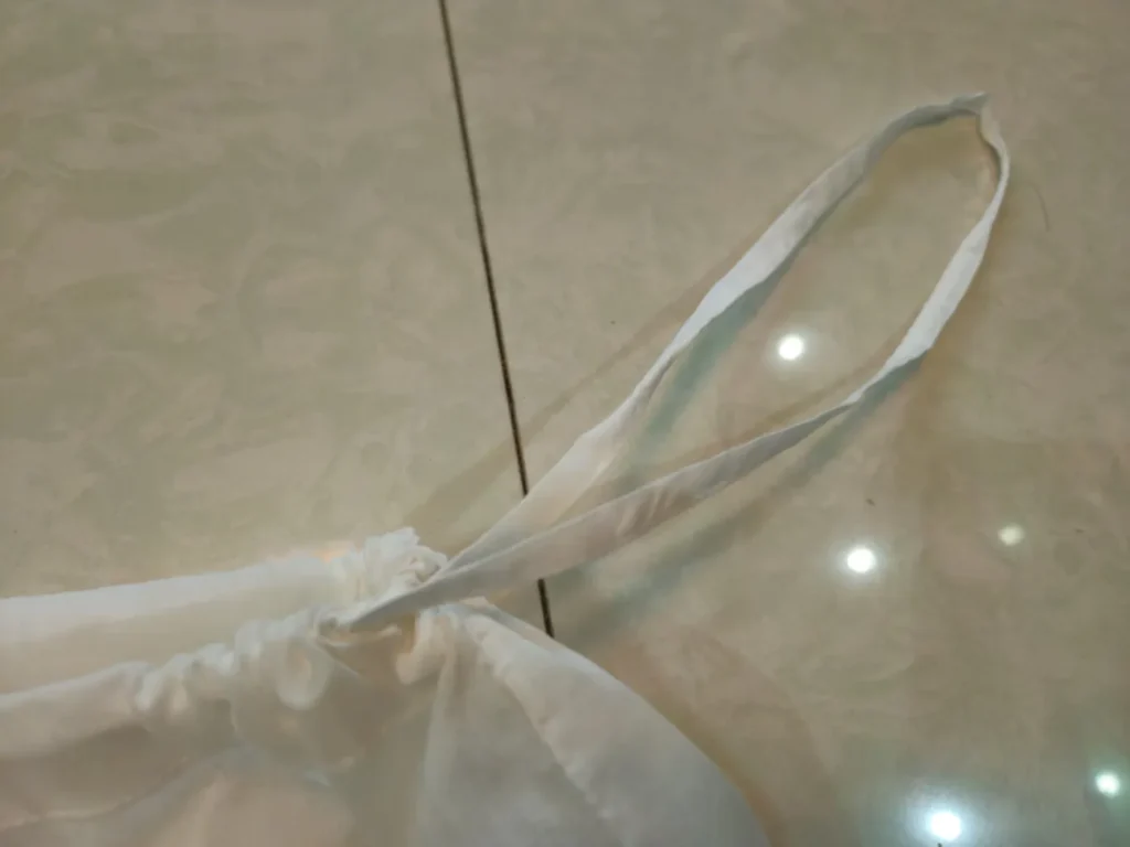 Drawstring and gathered opening of Walter G white cotton packaging bag